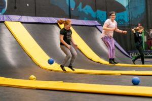 People jumping in the air on a trampoline